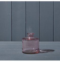 A small glass bottle in a pretty pink colour. 