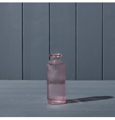 A pink glass vase featuring a ribbed design.