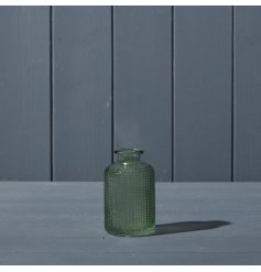 A beautiful dimpled glass bottle in a vintage green colour.