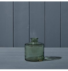 A decorative squat glass bottle in vintage green.