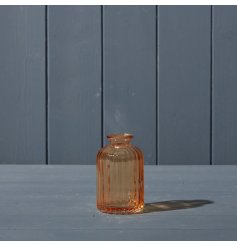 A ribbed design glass bottle in a beautiful rich cognac colour. 
