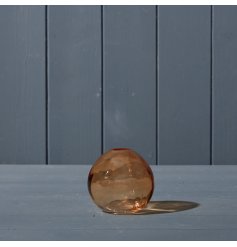 An unusually shaped glass globe vase in a rich cognac tone. 