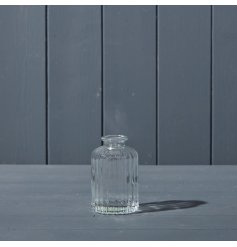A small clear ribbed glass bottle.
