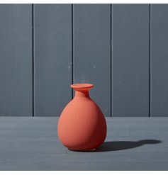 A terracotta coloured glass bud vase.