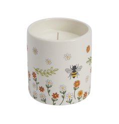A charming ceramic candle pot, decorated with a colourful and cute bee and flower design