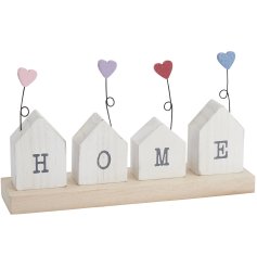 A charming and unique wooden HOME sign, featuring an assortment of contemporary 3D houses, each with a coloured heart 