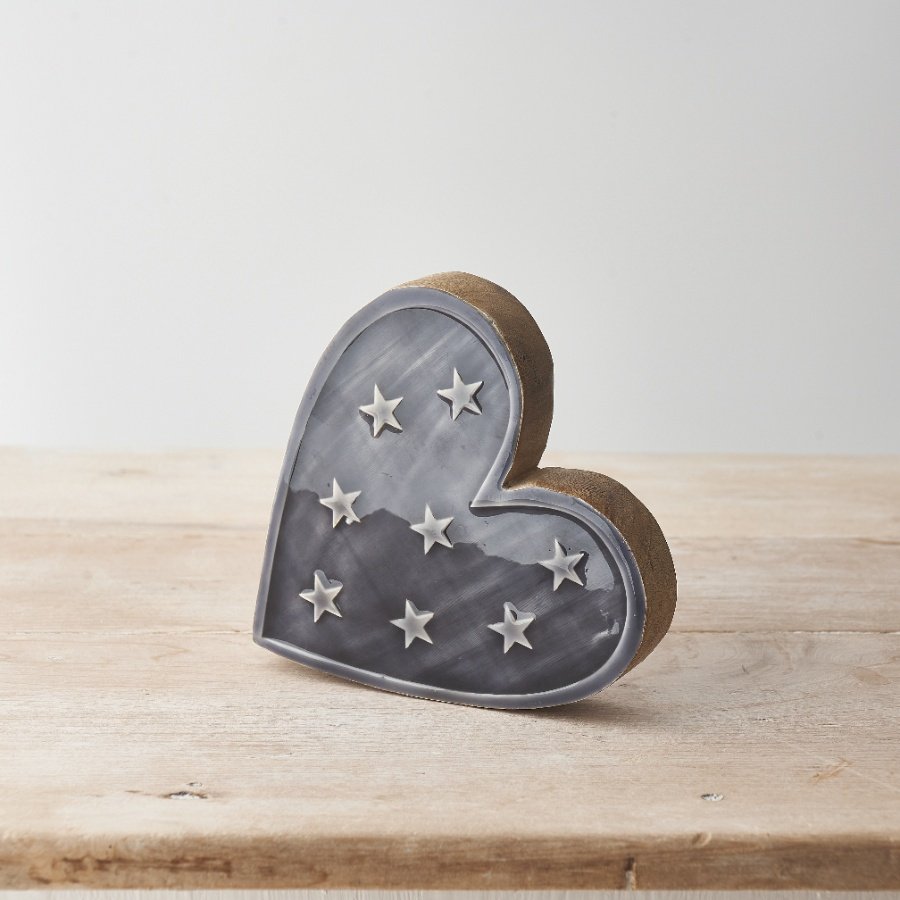 A chic heart shaped ornament made from chunky mango wood. Detailed with stars and complete with an enamel glaze
