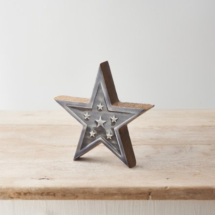 A rustic mango wood star with an earthy grey enamel glaze with star detailing. A must have interior accessory