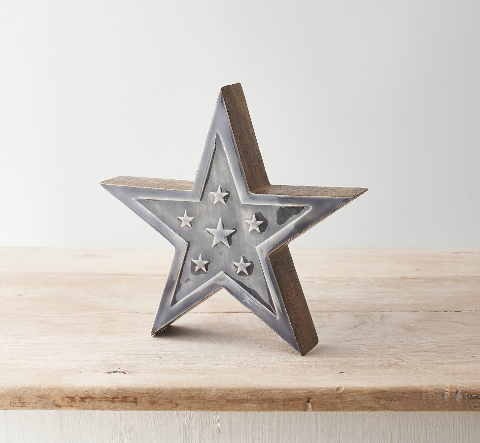 A chic star shaped decoration made from chunky mango wood. Detailed with mini stars and complete with a glossy glaze.