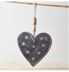 A stylish mango wood heart hanger with a star scattered enamel glaze and chunky rope hanger.
