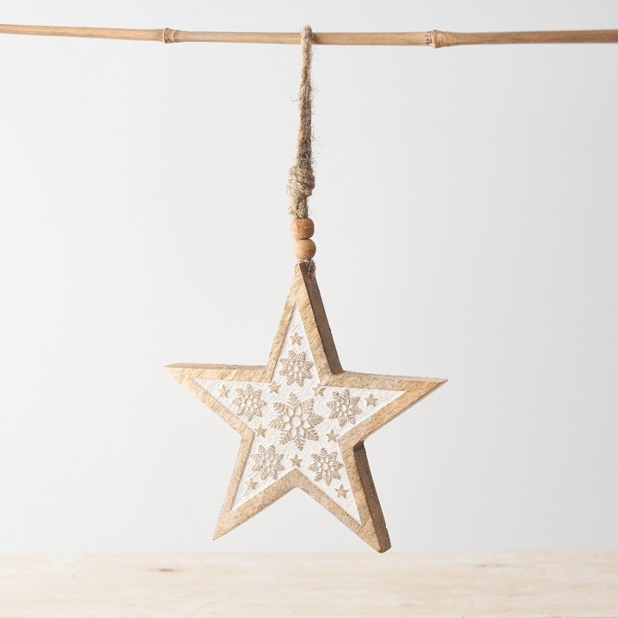 A chic star shaped hanging decoration made from natural mango wood. Beautifully carved with snowflakes