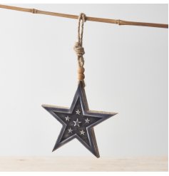 A rough luxe chunky wooden star hanger with a glossy enamel glaze and beaded rope.