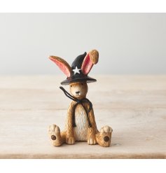 A charming resin bunny. Beautifully detailed with a black bow and a witches hat. 