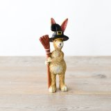 A halloween themed rabbit decorations featuring witches hat and broom details. 
