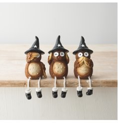 A set of 3 beautifully detailed wise owl ornaments, each with a black witches hat and dangling legs. 