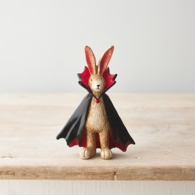 A beautifully detailed resin bunny ornament, dressed for a party in a wonderful black and red vampire cape. 