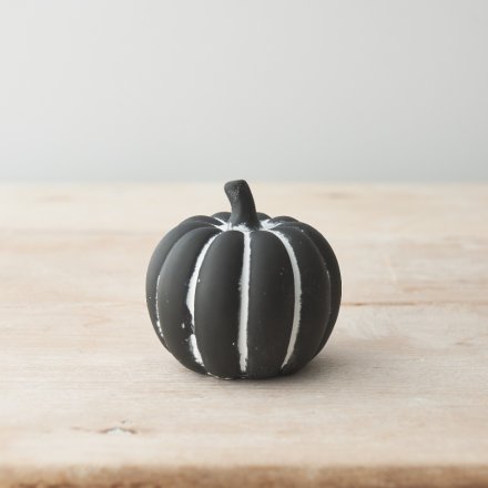 A must have cement pumpkin ornament with a black and white hand painted finish. 