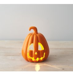 A fabulous ceramic pumpkin t-light holder with a rich orange glaze and spooky carved face. 