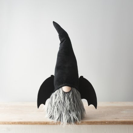 A unique Gonk decoration for spooky season. A plush Gonk figure with bat wings and a tall hat. 
