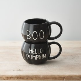 A unique pumpkin shaped ceramic mug with a glossy black glaze and embossed HELLO PUMPKIN slogan. 