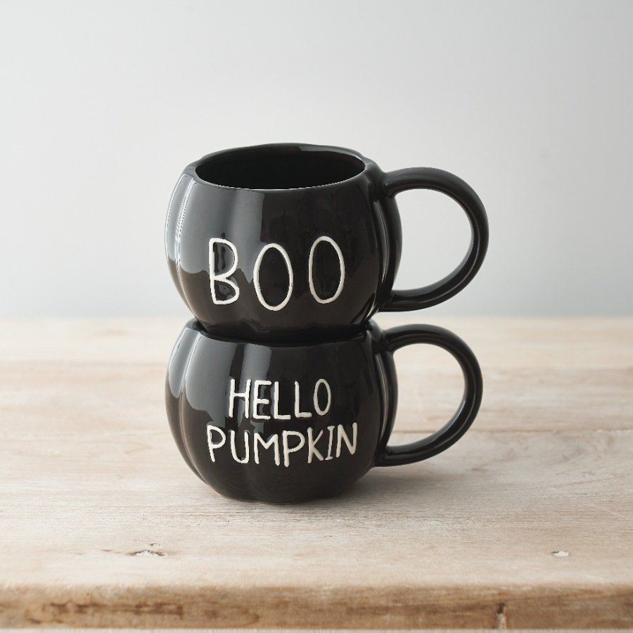 A unique pumpkin shaped ceramic mug with a glossy black glaze and embossed HELLO PUMPKIN slogan. 