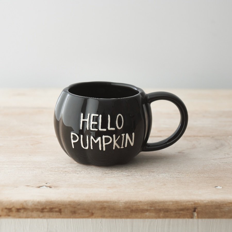 A unique pumpkin shaped ceramic mug with a glossy black glaze and embossed HELLO PUMPKIN slogan. 