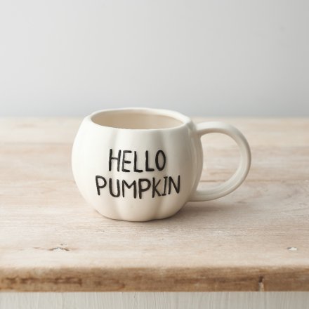 A charming pumpkin shaped ceramic mug with a white glaze and embossed HELLO PUMPKIN slogan. 