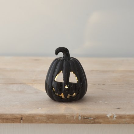 A stylish black ceramic pumpkin t-light holder. Complete with a spooky carved face. 