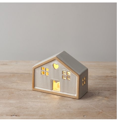 A charming natural house with a heart detail and warm glow led lights. 