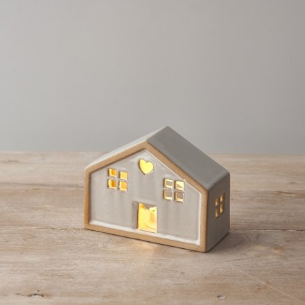 A charming natural house with a heart detail and warm glow led lights. 