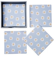 A beautiful set of 4 coasters, each with a pretty repeat daisy pattern on a pastel blue background. 