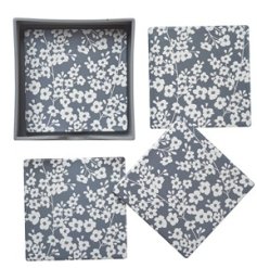 A set of 4 matching coasters featuring a pretty floral print pattern on a grey background. 