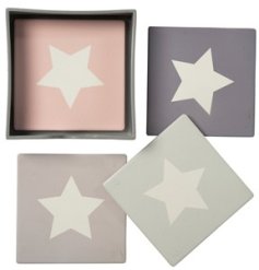 A set of 4 pastel coloured coasters, each with a contrasting white star motif. 