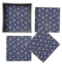 A set of 4 coasters each with a delicate snowflake pattern on a dark blue background. 