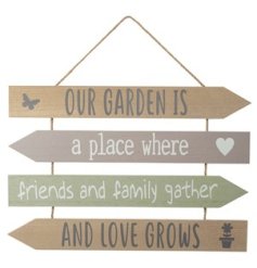 A slatted wooden sign with "our garden is a place where love grows" quote and butterfly, hearts and flower design detail