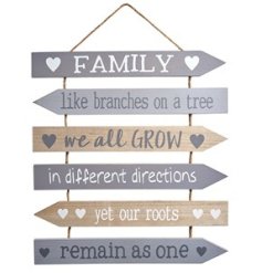 A large wooden slatted sign with sentimental "family like branches on a tree we all grow in different directions" quote.