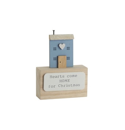 A decorative wooden block featuring "hearts come home for Christmas" quote, 3D house design and heart detail.