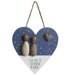 A pretty heart shaped wooden hanging sign, with pebble couple and heart detail and "love you to the moon and back" text.