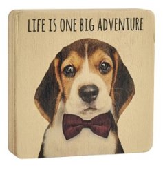 A decorative wooden block with "life is one big adventure" text and a dapper dog in a bow tie print.