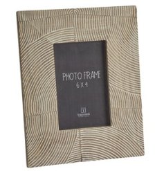 A stylish chunky wooden photo frame with a carved wave design.
