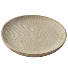 A chunky wooden dish with a natural carved wave design. A stylish interior accessory, ideal for display on coffee tables