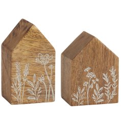 An assortment of 2 wooden block houses, each with an etched floral meadow design. 