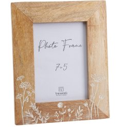 A stylish photo frame with wooden frame featuring a floral meadow design. 