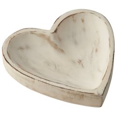 A heart shaped wooden dish with a white wash. A charming rustic decorative item for the home. 