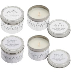 An assortment of tinned candles, each with a white tea & jasmine scent and a pretty floral meadow print.