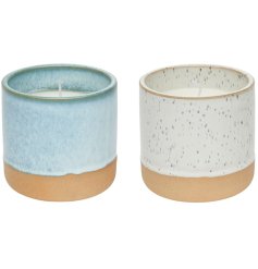 Terracotta dipped candle pots in blue and white. Two assorted scented candles. 
