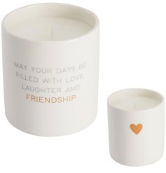 A stylish and simplistic candle with heart detail and a beautiful quote about friendship.