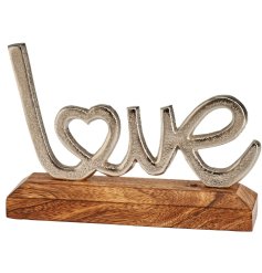 A beautiful item depicting the word "love" with incorporated heart detail presented on a wooden base.