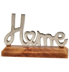 A stunning item depicting the word "home" in a silver metal finish and heart detail on a wooden base. 