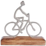 A decorative silver cyclist silhouette presented on a contrasting wooden base. 